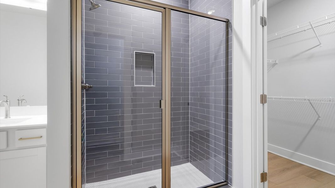 Highly functional and elegant en-suite with dual vanities, tiled walk-in shower, and refined finishes