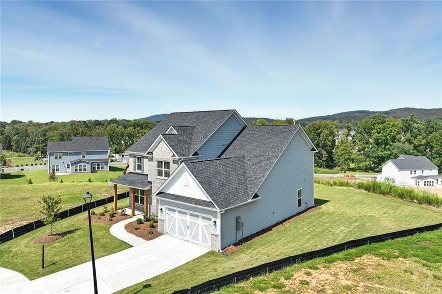 Front exterior of a new home in Berkeley Mill, Cumming, GA, highlighting curb appeal (Image 24). Front exterior of a new home in Berkeley Mill, Cumming, GA, highlighting curb appeal (Image 24).