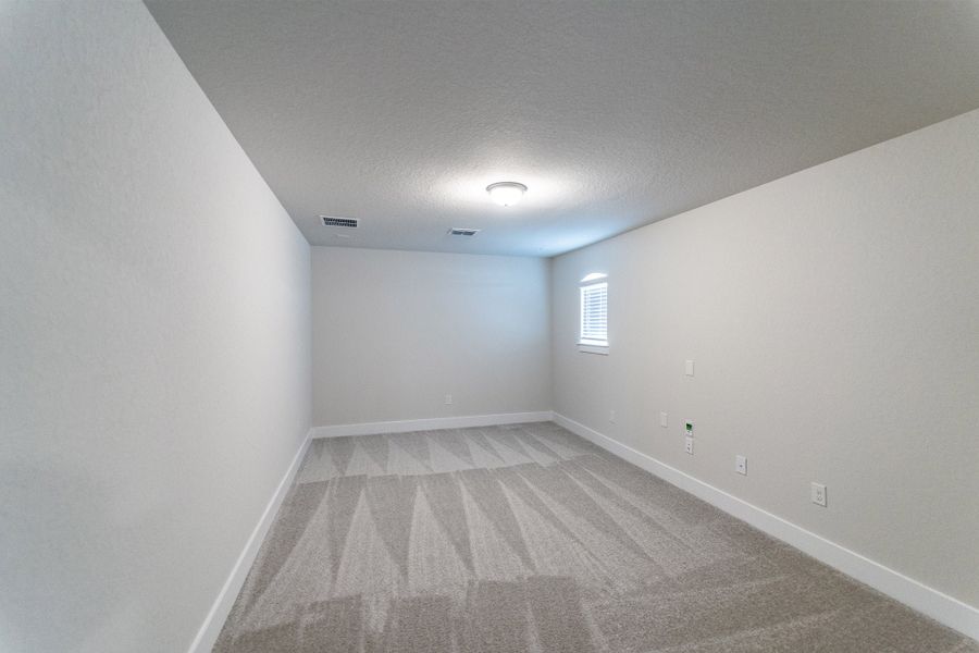 Spacious, unfurnished interior of a new home in The Woodlands at Medina Hills, Mico (Image 20).