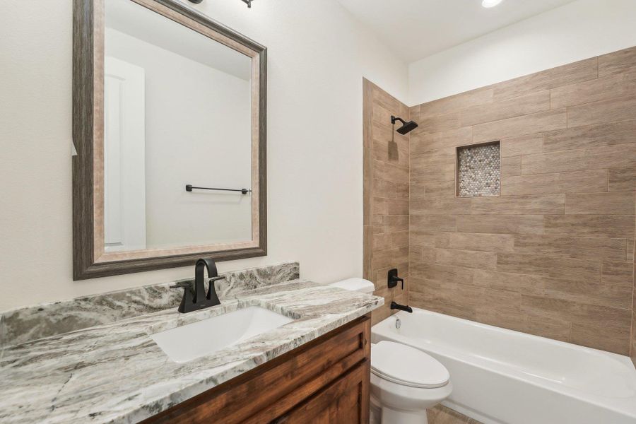Full bath with vanity, shower combination, and toilet Full bath with vanity, shower combination, and toilet