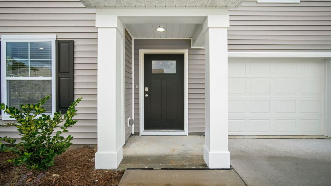 Exterior details and patio area of a home in Cobblestone Village, Savannah (Image 3).