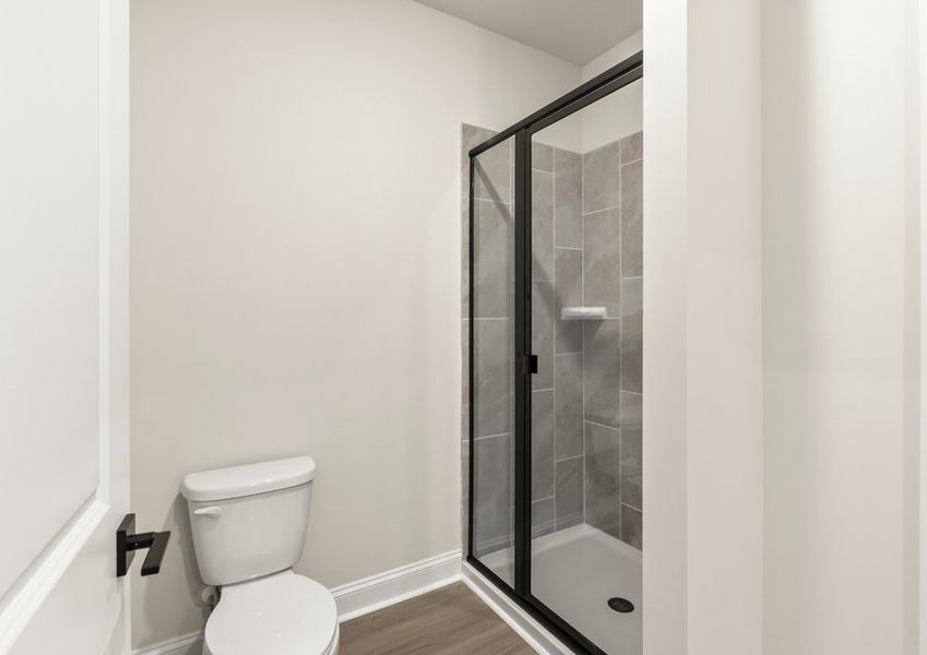 This bathroom has a glass-enclosed shower