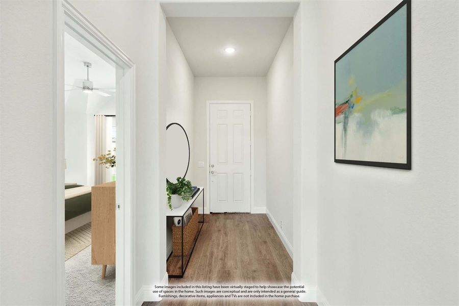 Narrow hallway with wood floors, white walls, small console table, and framed wall art leading to a white door Narrow hallway with wood floors, white walls, small console table, and framed wall art leading to a white door