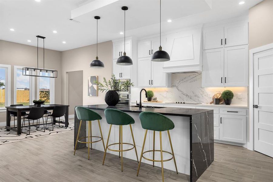 Kitchen featuring backsplash, sink, white cabinets, and custom exhaust hood