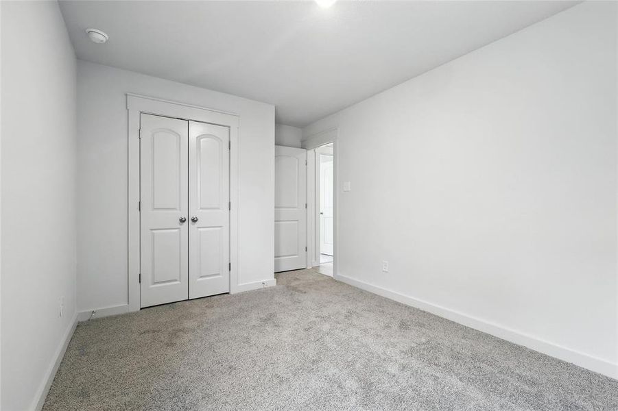 Unfurnished bedroom with carpet floors and a closet Unfurnished bedroom with carpet floors and a closet
