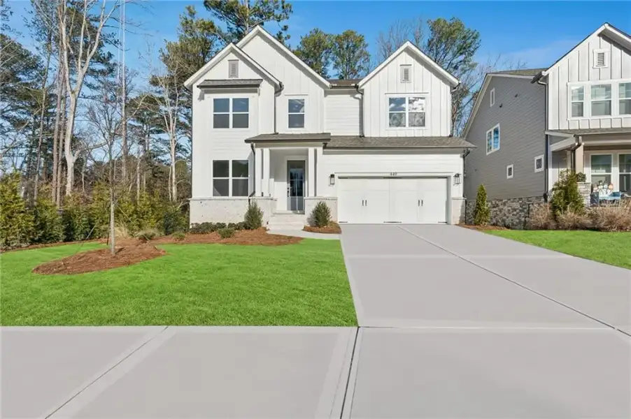 Front exterior of a new home in Havencroft, Woodstock, GA, highlighting curb appeal (Image 1). Front exterior of a new home in Havencroft, Woodstock, GA, highlighting curb appeal (Image 1).