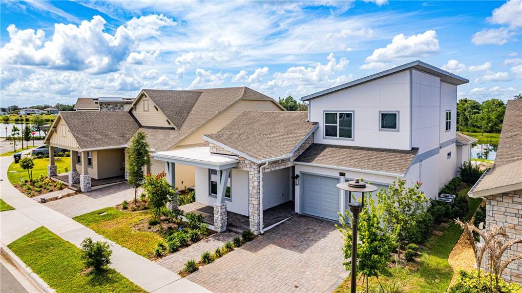 Front exterior of a new home in Laureate Park (Craft Homes), Orlando, FL, highlighting curb appeal (Image 22). Front exterior of a new home in Laureate Park (Craft Homes), Orlando, FL, highlighting curb appeal (Image 22).