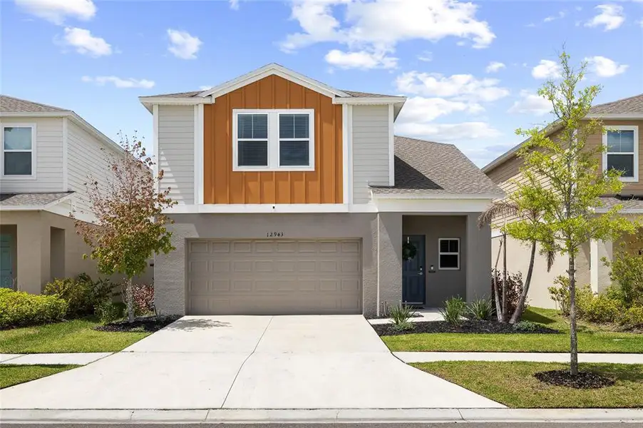 Front exterior of a new home in Hawkstone, Lithia, FL, highlighting curb appeal (Image 21).