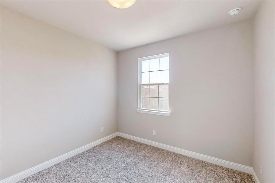 Spare room featuring carpet flooring