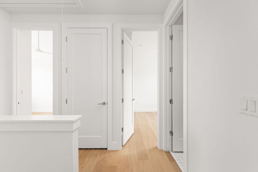 Hall featuring attic access and light wood-style flooring