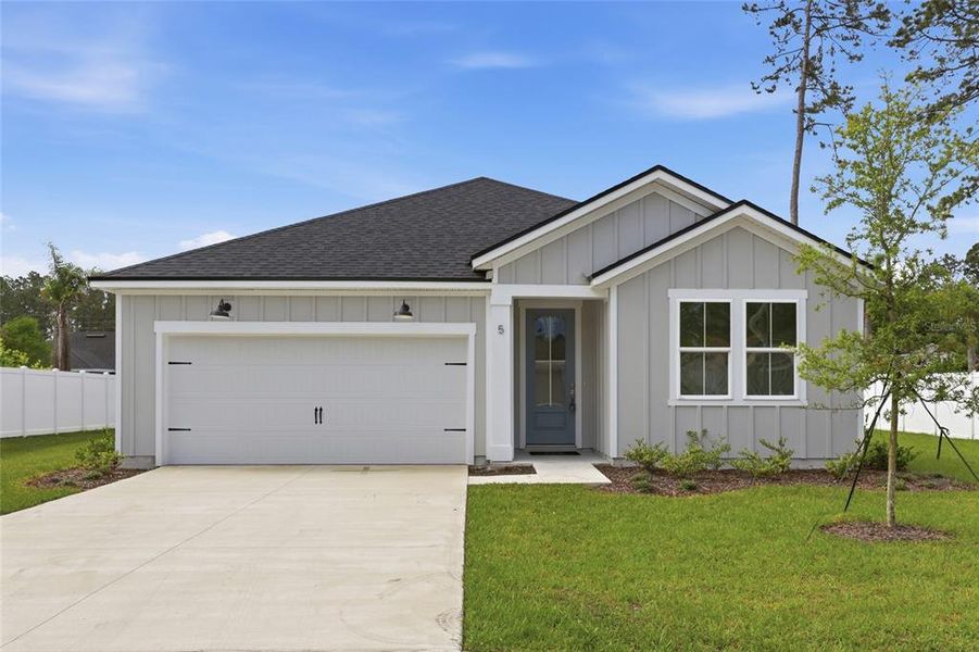 Front exterior of a new home in Palm Coast Homes, Palm Coast, FL, highlighting curb appeal (Image 27).