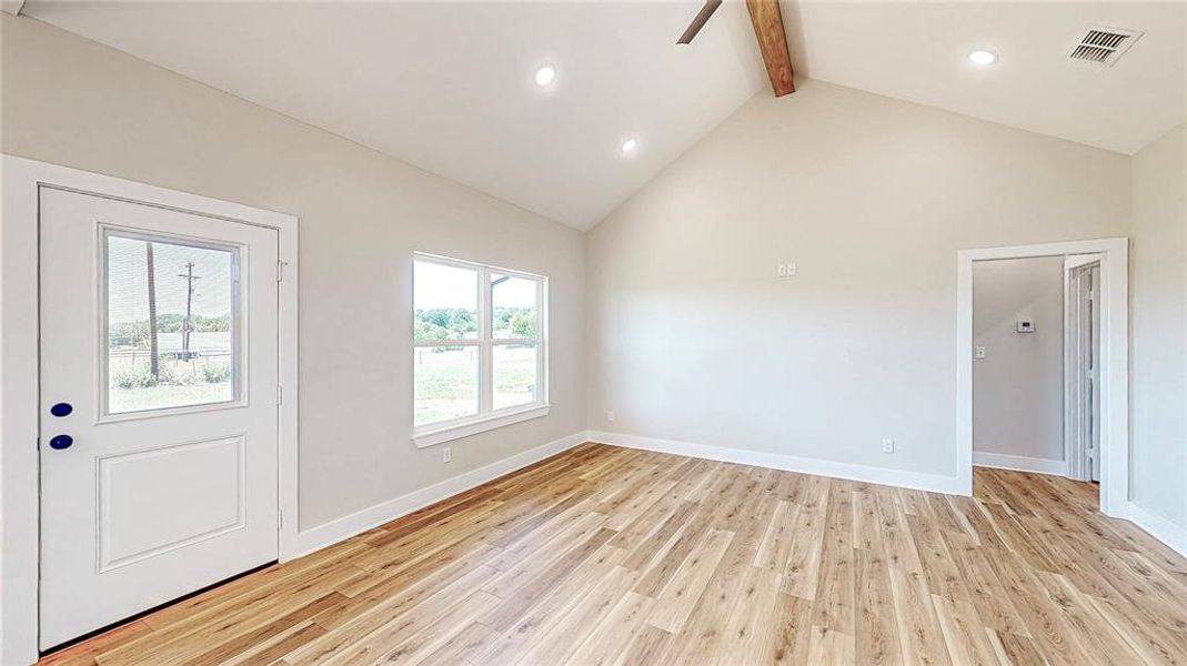 Foyer featuring beam ceiling, light wood-style floors, high vaulted ceiling, and recessed lighting Foyer featuring beam ceiling, light wood-style floors, high vaulted ceiling, and recessed lighting