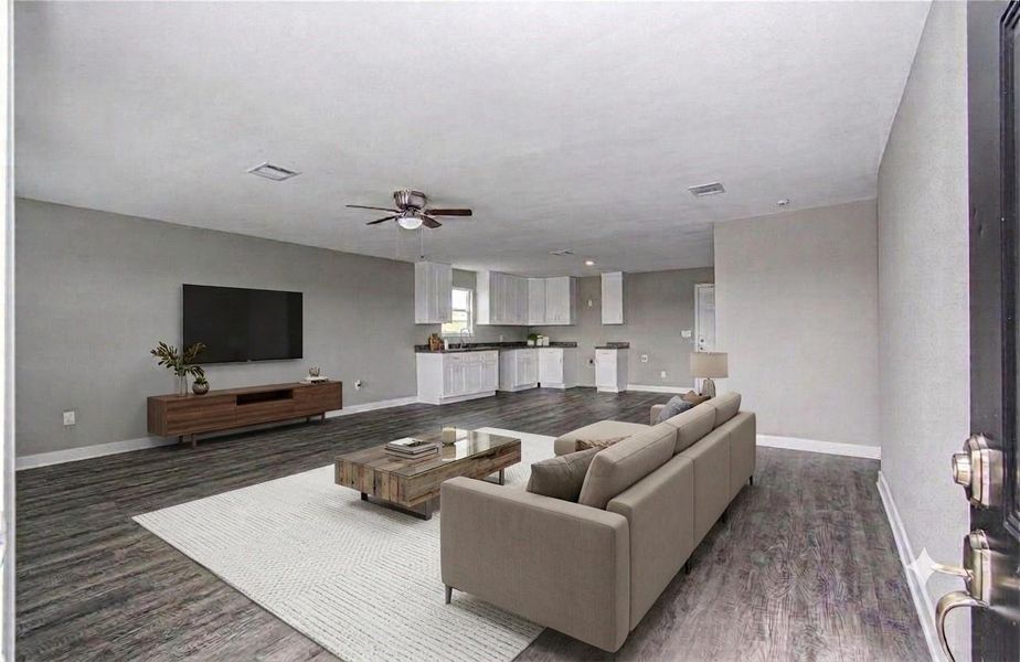 Open-concept living and kitchen area.(Virtually Staged)