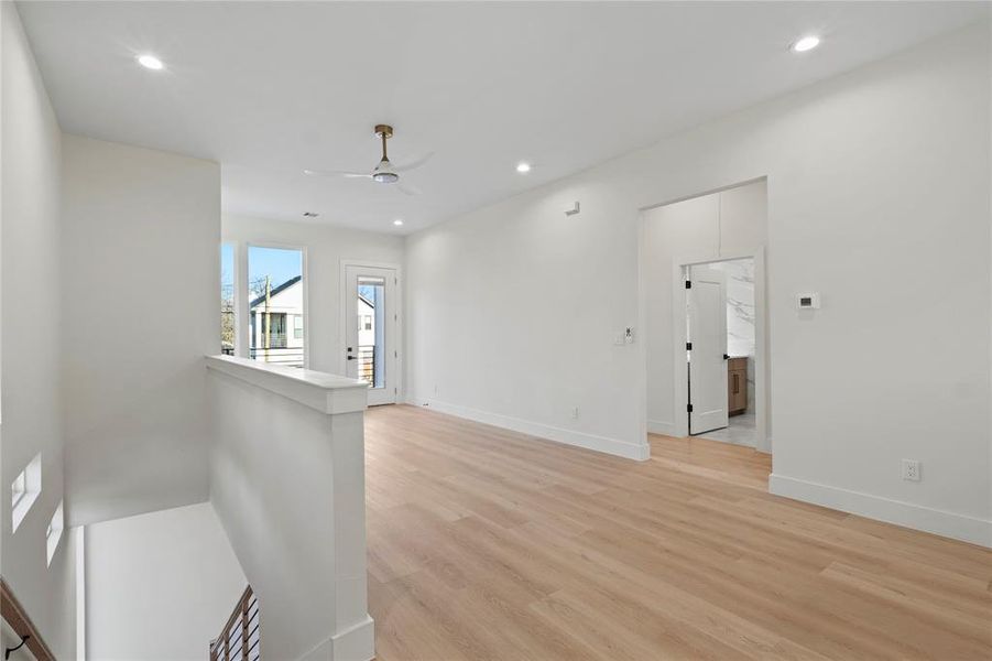 Spare room featuring baseboards, recessed lighting, a ceiling fan, and light wood-style floors