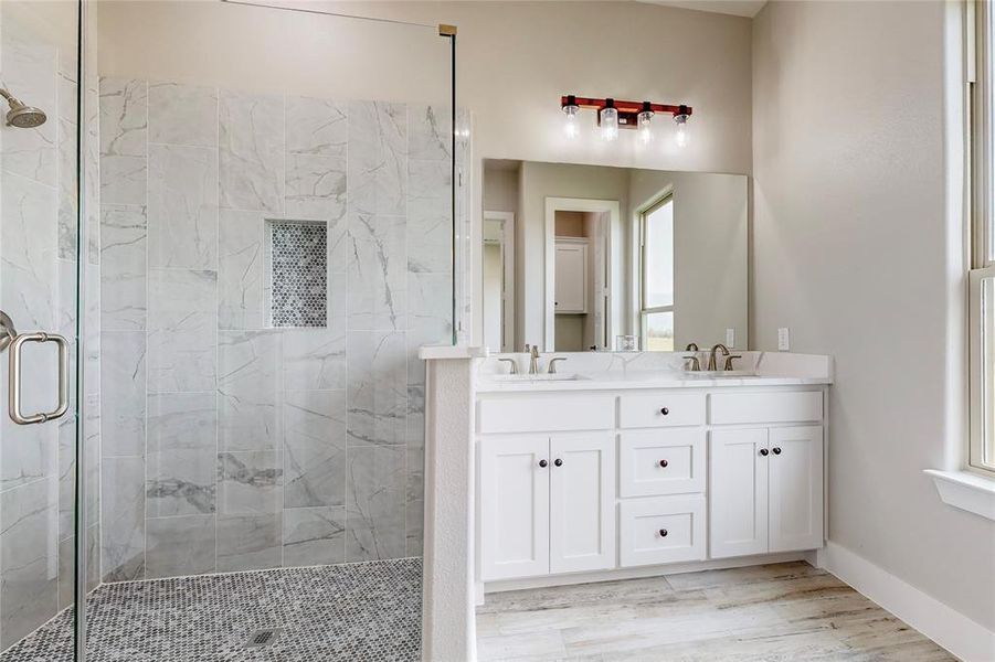 Bathroom with a shower with door, vanity, and wood-type flooring