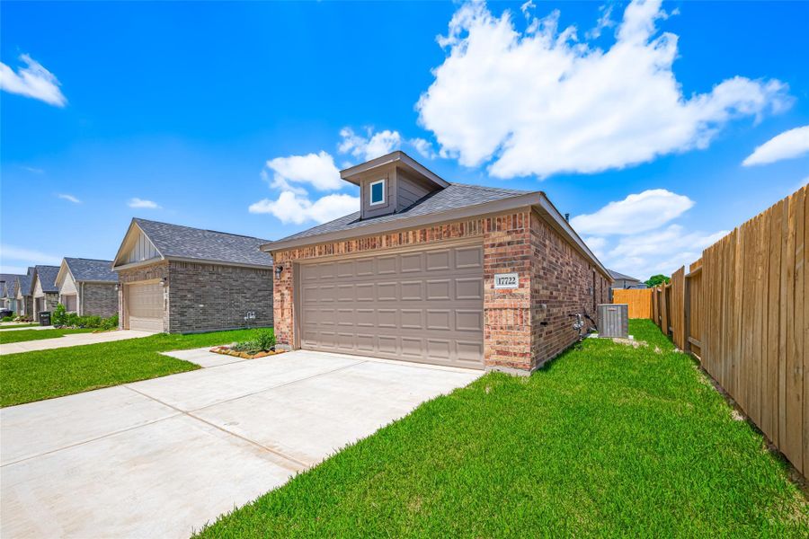 Front exterior of a new home in Sunterra, Katy, TX, highlighting curb appeal (Image 24).
