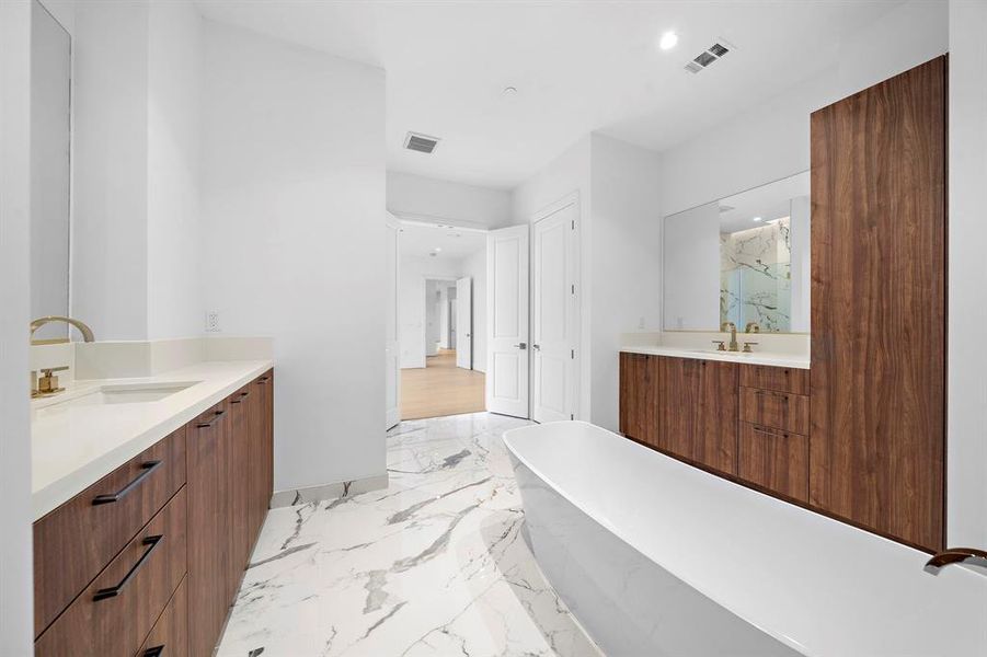 Primary Bath invites relaxation with deep soaking tub, oversized shower & dual vanity.