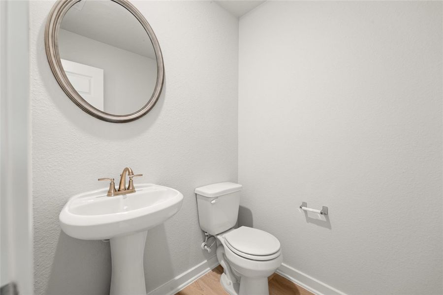 This powder room offers a clean and modern design with neutral tones, a pedestal sink, and elegant fixtures—ideal for guests and everyday convenience. This powder room offers a clean and modern design with neutral tones, a pedestal sink, and elegant fixtures—ideal for guests and everyday convenience.
