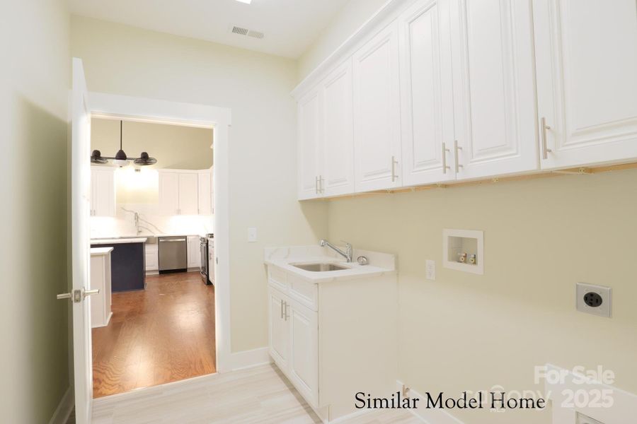 Spacious laundry room with Abundant storage for easy organization Spacious laundry room with Abundant storage for easy organization