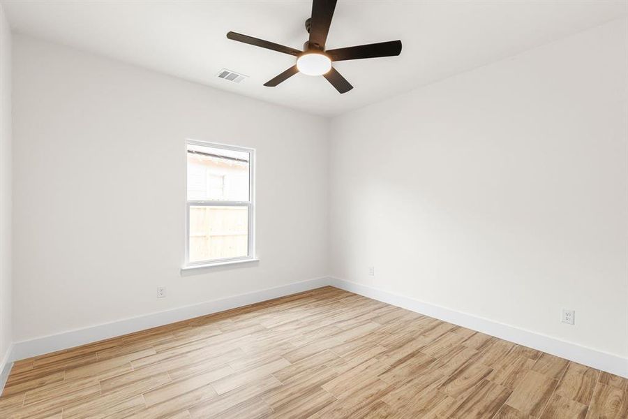 Unfurnished room featuring ceiling fan and light hardwood / wood-style floors