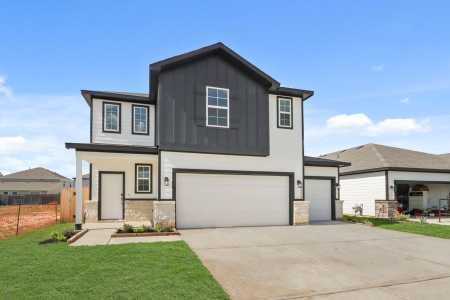 Front exterior of a new home in Caney Mills, Cut and Shoot, TX, highlighting curb appeal (Image 2).
