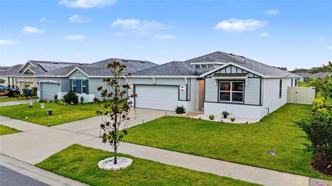 Front exterior of a new home in Abbott Park, Zephyrhills, FL, highlighting curb appeal (Image 23).