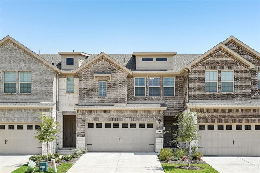 View of front of home featuring driveway, roof with shingles, brick siding, and an attached garage View of front of home featuring driveway, roof with shingles, brick siding, and an attached garage