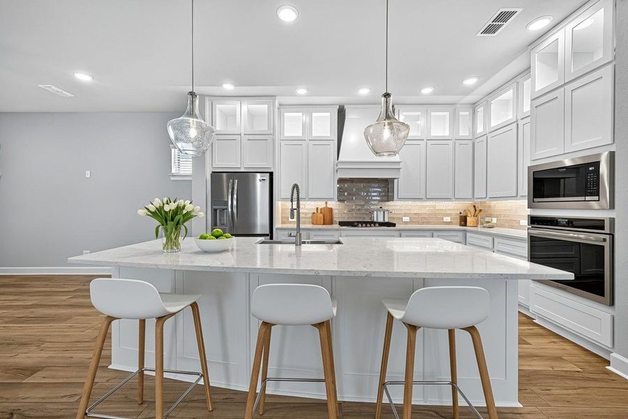 Discover the elegance of this virtually staged kitchen, featuring sleek white cabinetry, modern appliances, and a spacious island perfect for entertaining.