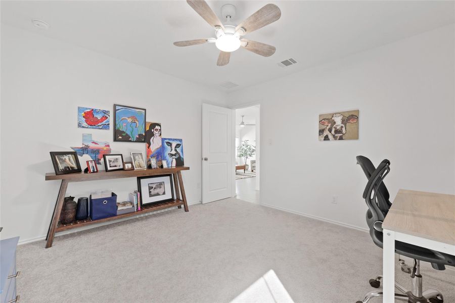 Office space featuring light carpet and ceiling fan