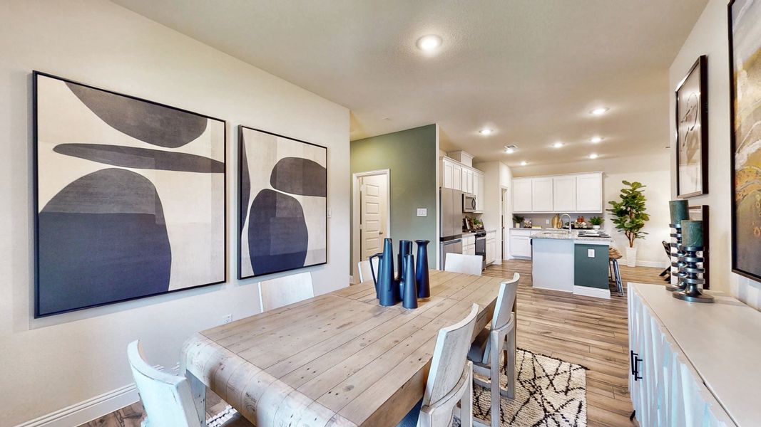 A dining room with a table and chairs. A dining room with a table and chairs.