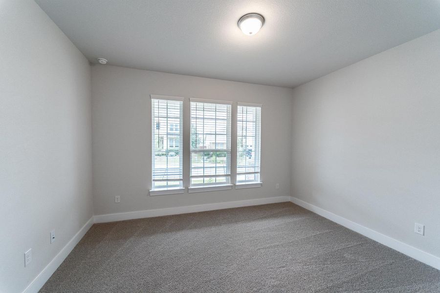 Carpeted empty room with baseboards