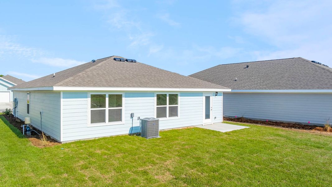 Front exterior of a new home in Owl's Head Farms, Freeport, FL, highlighting curb appeal (Image 16). Front exterior of a new home in Owl's Head Farms, Freeport, FL, highlighting curb appeal (Image 16).