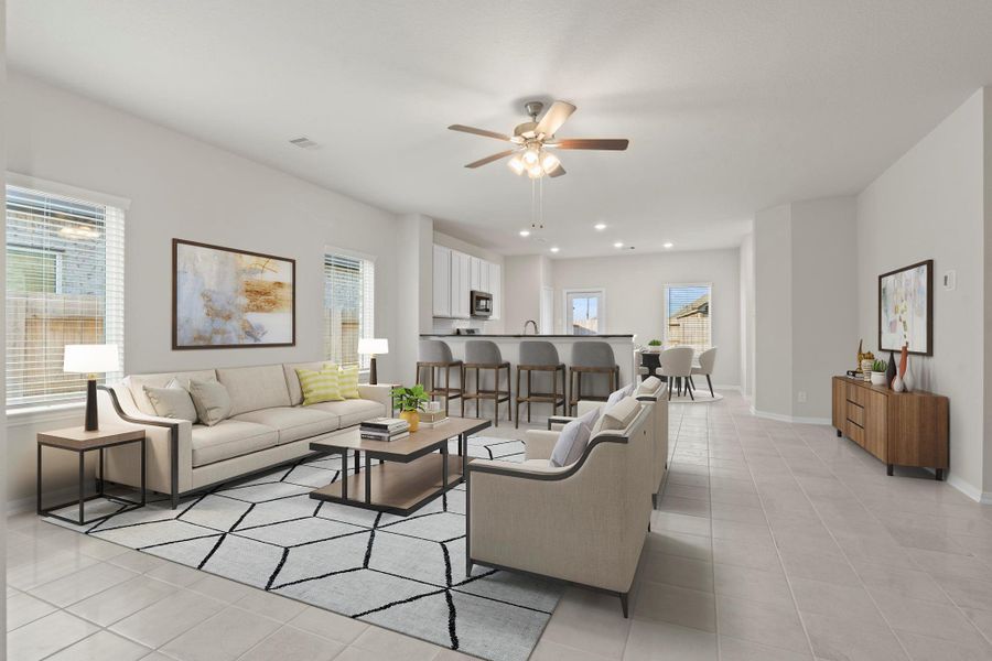 The virtually staged family room highlights the home’s open-concept design, showing how easily the space accommodates both daily living and entertaining. Bright windows, tile flooring, and a cozy setup bring this beautiful room to life.  Carefree large tile floors!