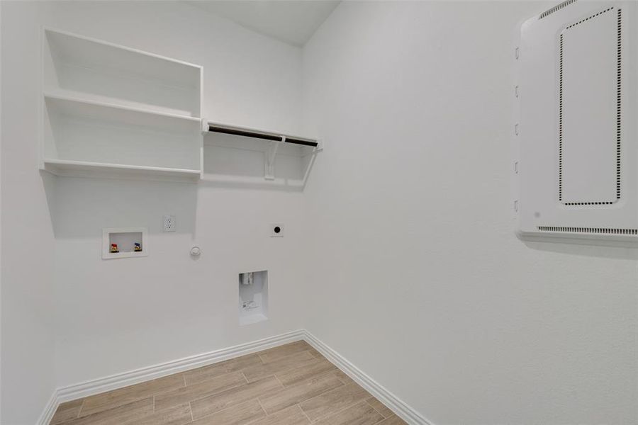 Laundry area featuring hookup for a gas dryer, washer hookup, and hookup for an electric dryer