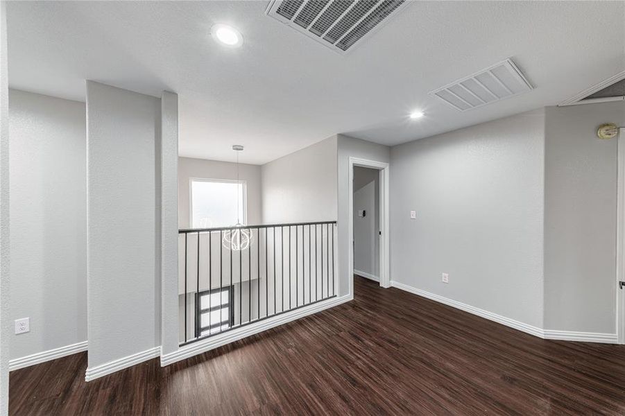 Unfurnished room with dark wood-style floors and recessed lighting