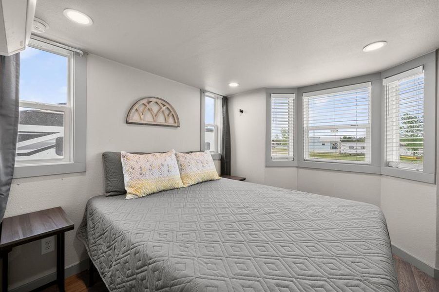 Down the hallway is the primary bedroom with plenty of windows!