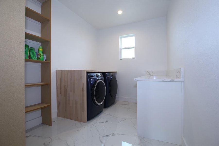 Washroom with independent washer and dryer, light marble finish flooring, and recessed lighting Washroom with independent washer and dryer, light marble finish flooring, and recessed lighting