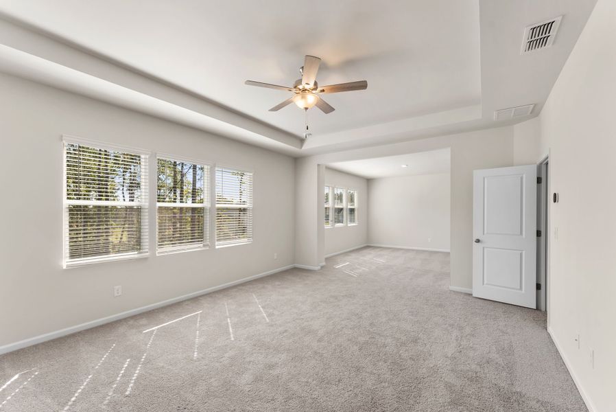 A room with a ceiling fan and a window.