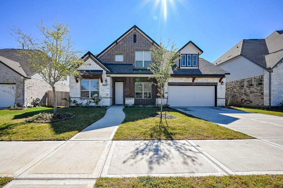 Front exterior of a new home in StoneCreek Estates, Richmond, TX, highlighting curb appeal (Image 25).