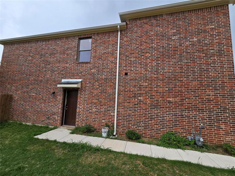 View of side of home with brick siding