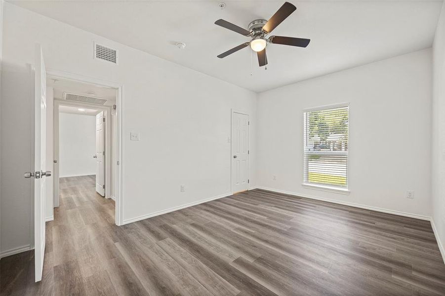 Featuring ceiling fan and dark wood-like flooring