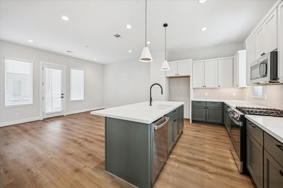 From the kitchen, you can overlook the living room, making it easy to stay connected with friends and loved ones while you cook.