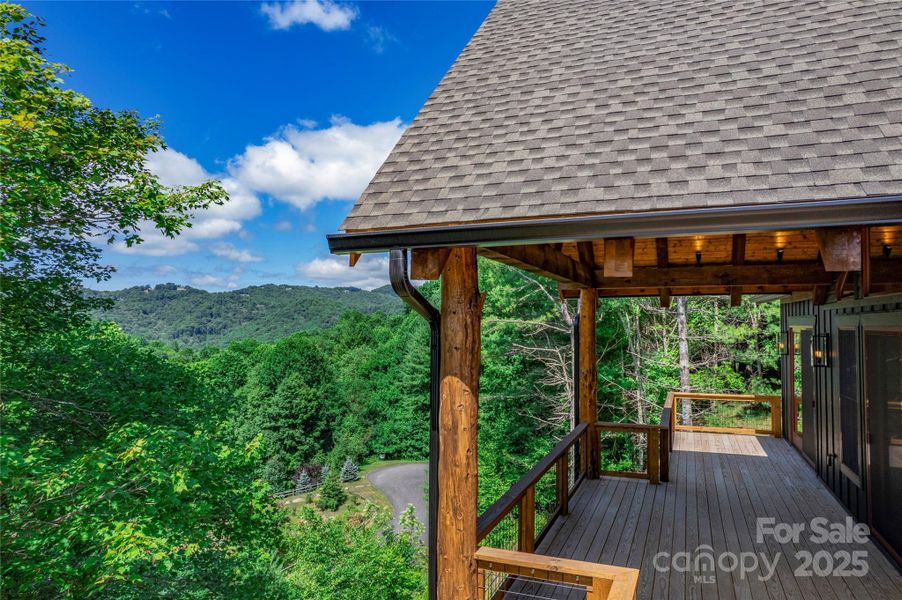Over 1,200 square feet of outdoor space including main level porte-cochere, covered porches with majestic, private mountain & neighborhood pond views