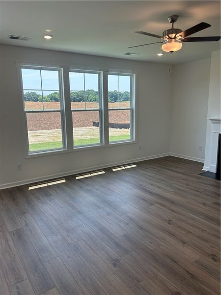 A spacious room features a ceiling fan, recessed l