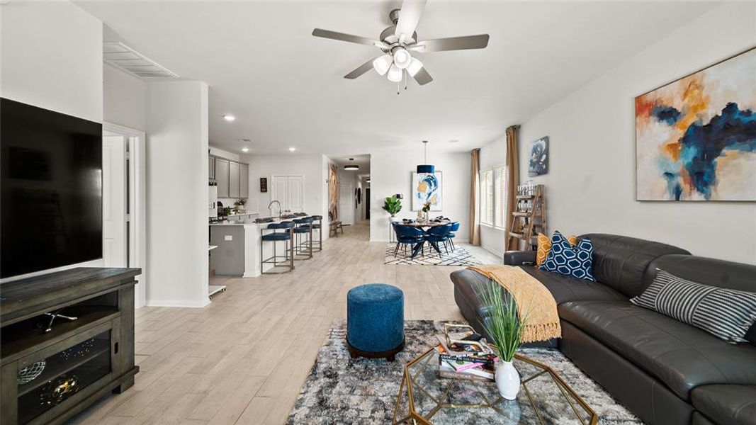 Here you will see the living room open to the kitchen, and dining room.