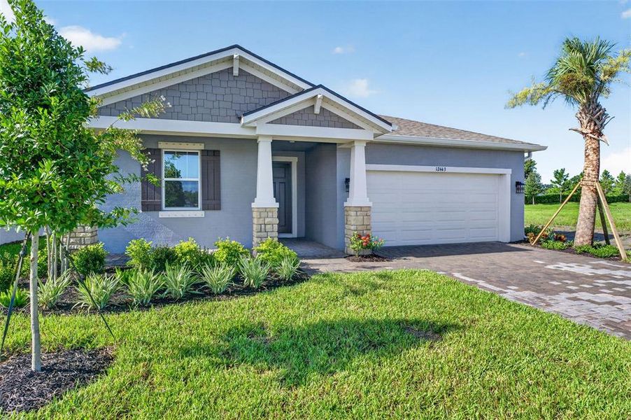 Front exterior of a new home in Windwater, Parrish, FL, highlighting curb appeal (Image 2). Front exterior of a new home in Windwater, Parrish, FL, highlighting curb appeal (Image 2).