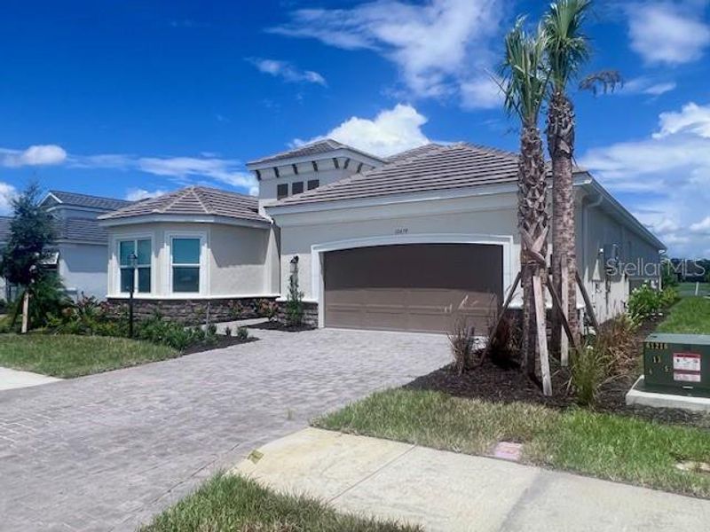 Front exterior of a new home in , Sarasota, FL, highlighting curb appeal (Image 26).