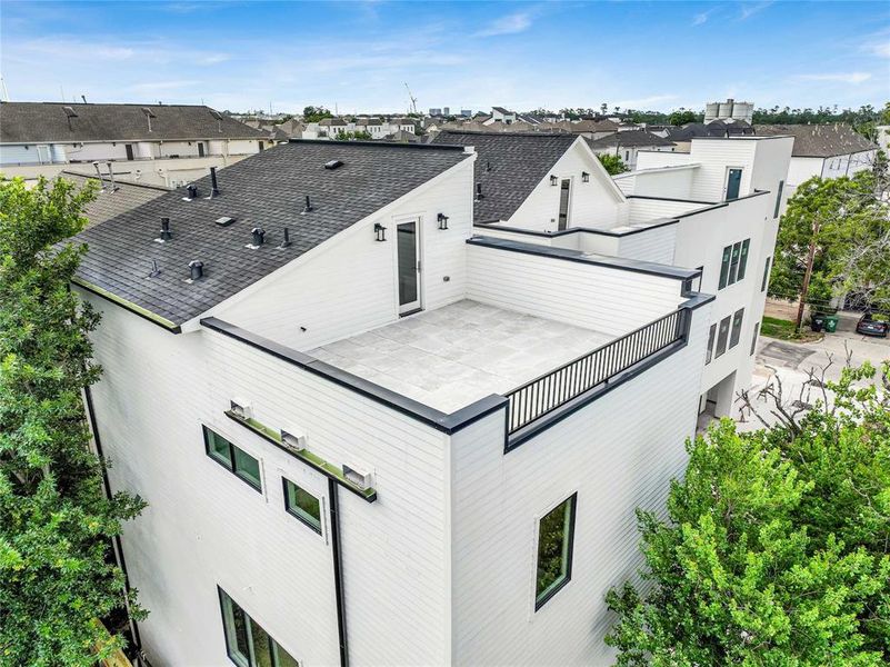 Captivating aerial view of a spacious rooftop terrace, perfect for outdoor relaxation and entertainment.