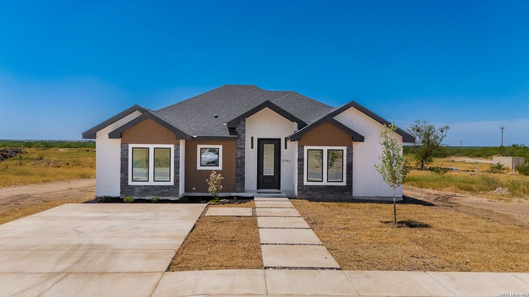 Front exterior of a new home in , Eagle Pass, TX, highlighting curb appeal (Image 23).