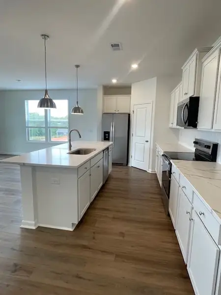 This bright kitchen features an island, ample coun